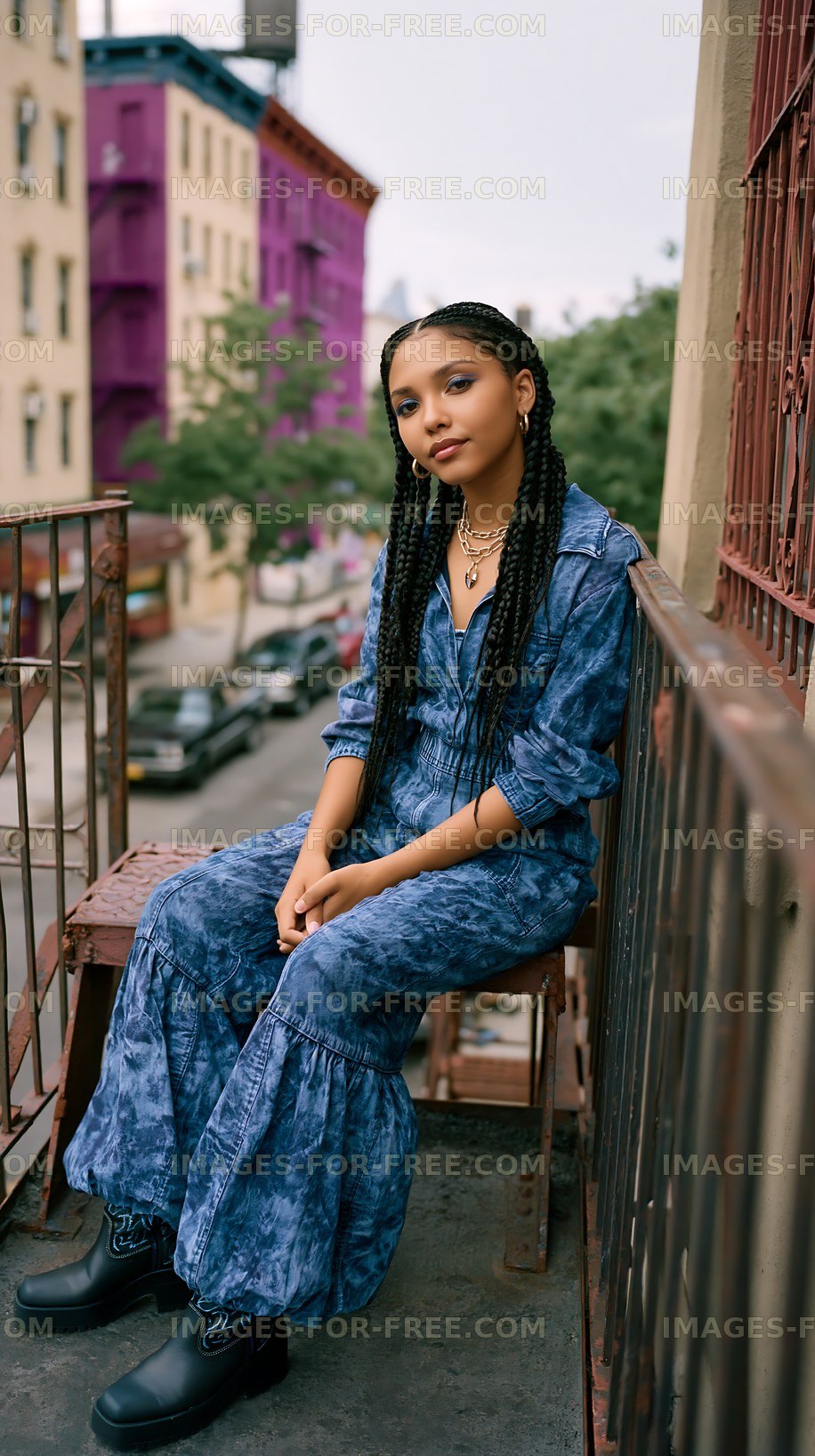 Young person sitting on balcony in urban area