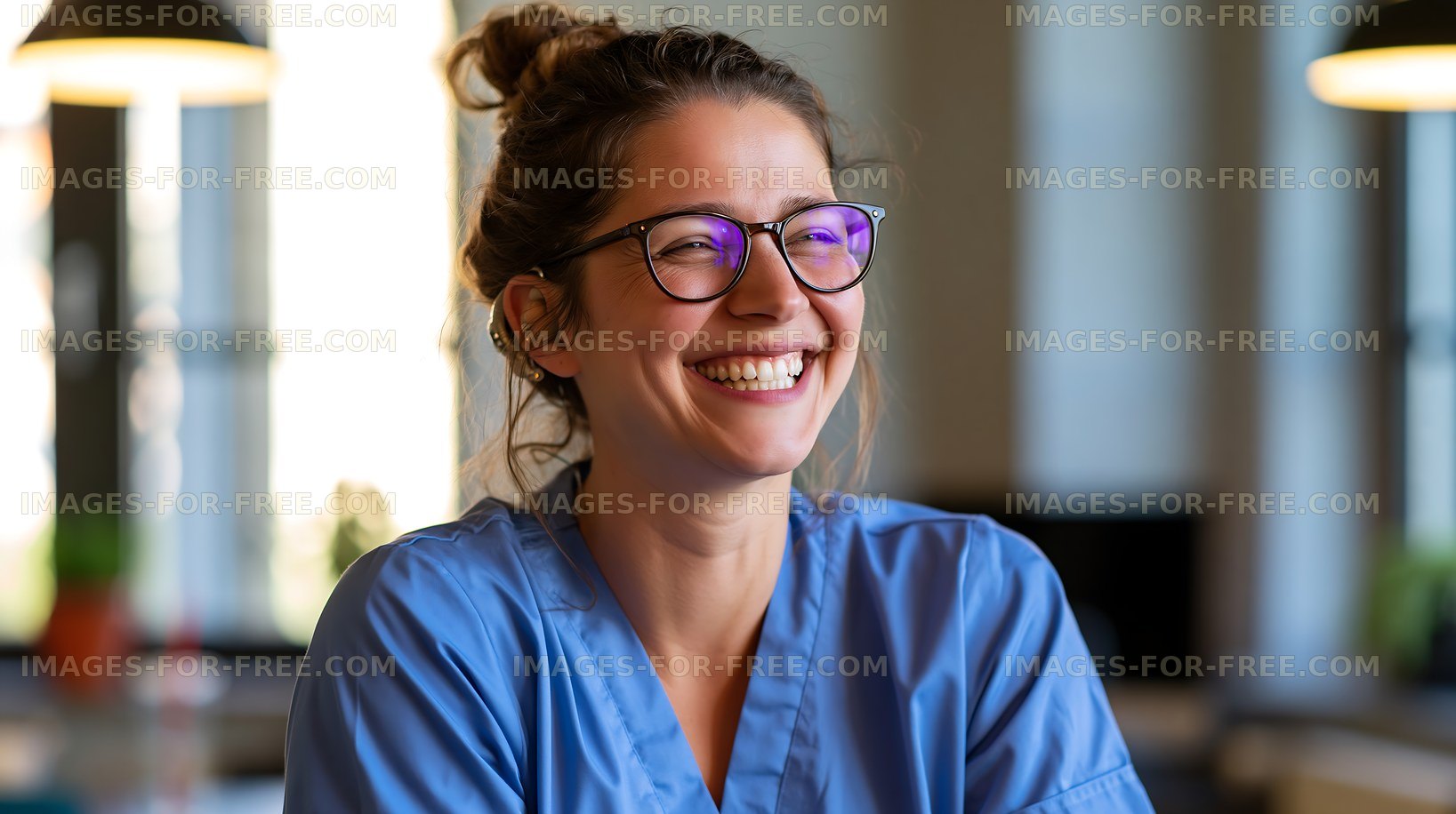 Smiling nurse in blue scrubs at a bright indoor setting