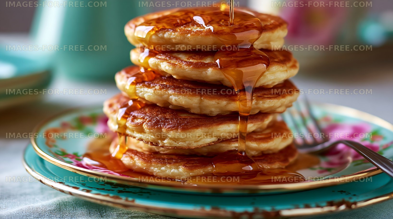 Stack of pancakes with syrup on a decorative plate