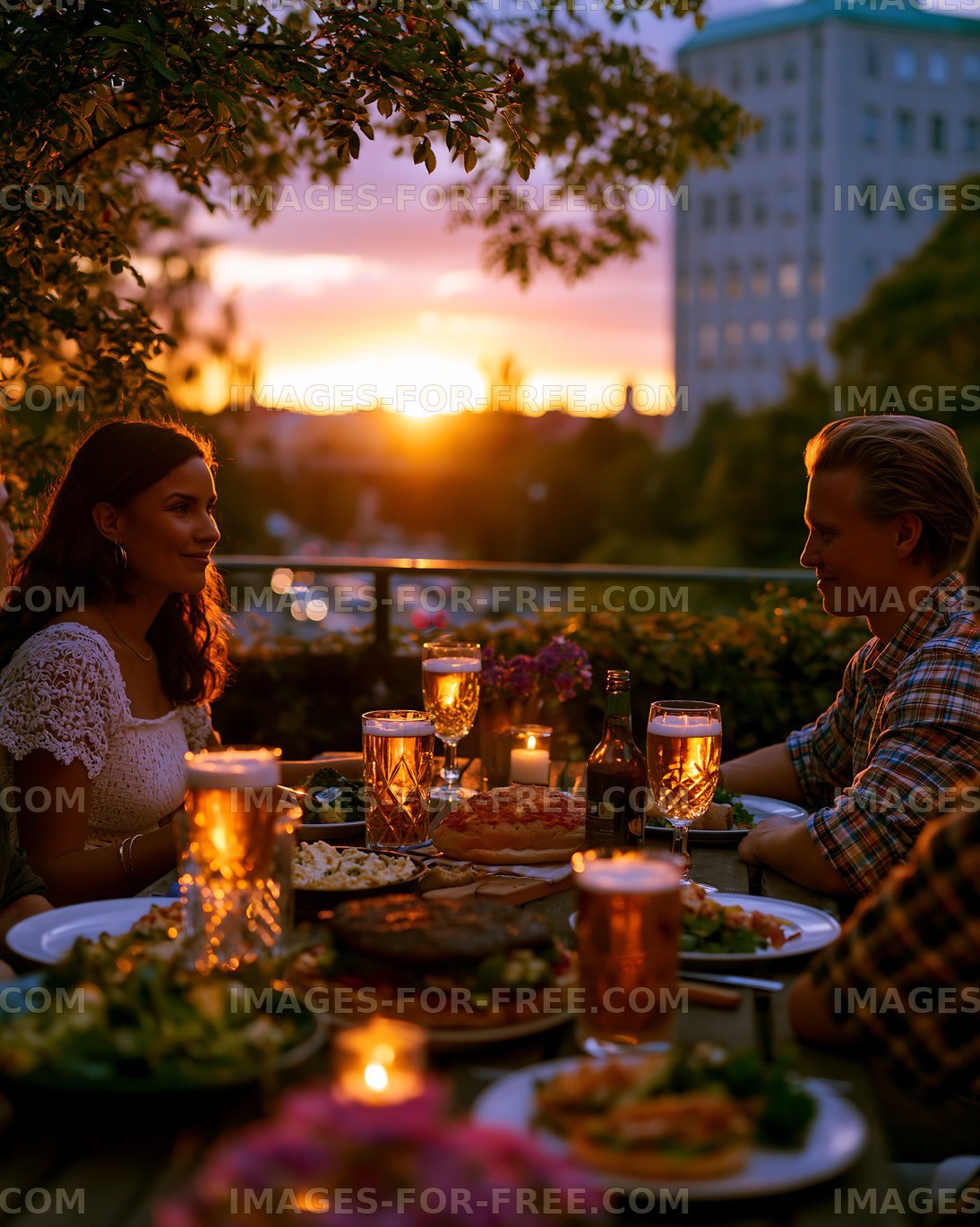Couple enjoys dinner with drinks during sunset at outdoor table