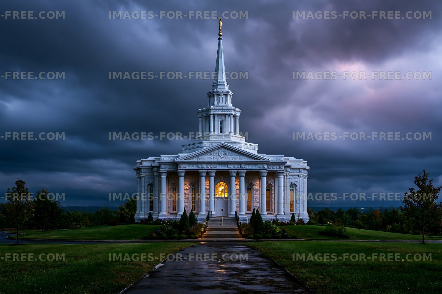 Building with a tall spire under a cloudy sky in the evening