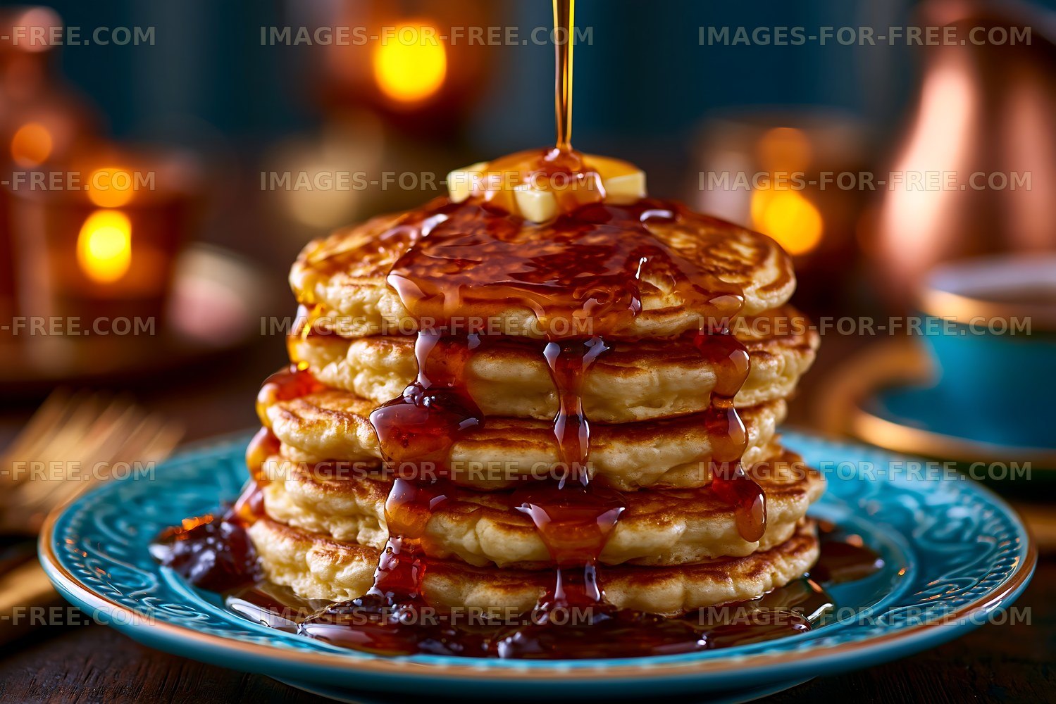 Stack of pancakes with syrup and butter on a blue plate