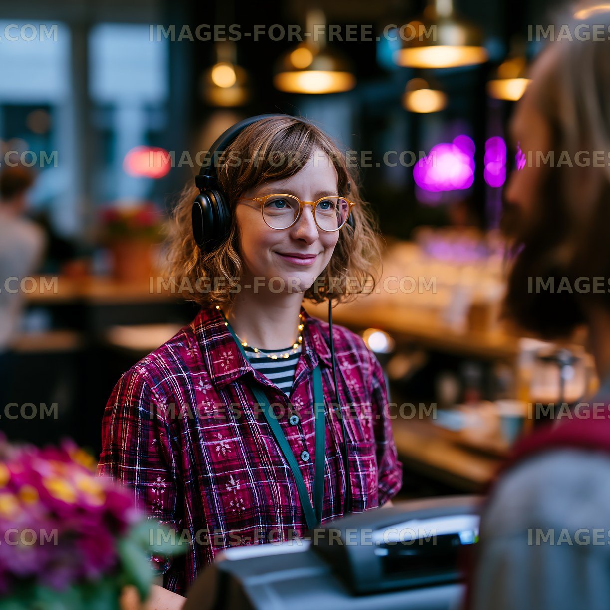 Barista serving coffee at a busy cafe in the evening