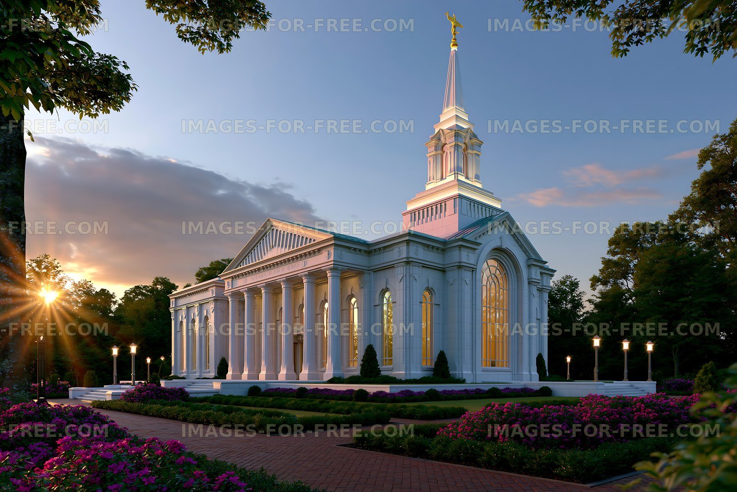 Building with white pillars and a tall spire at sunset