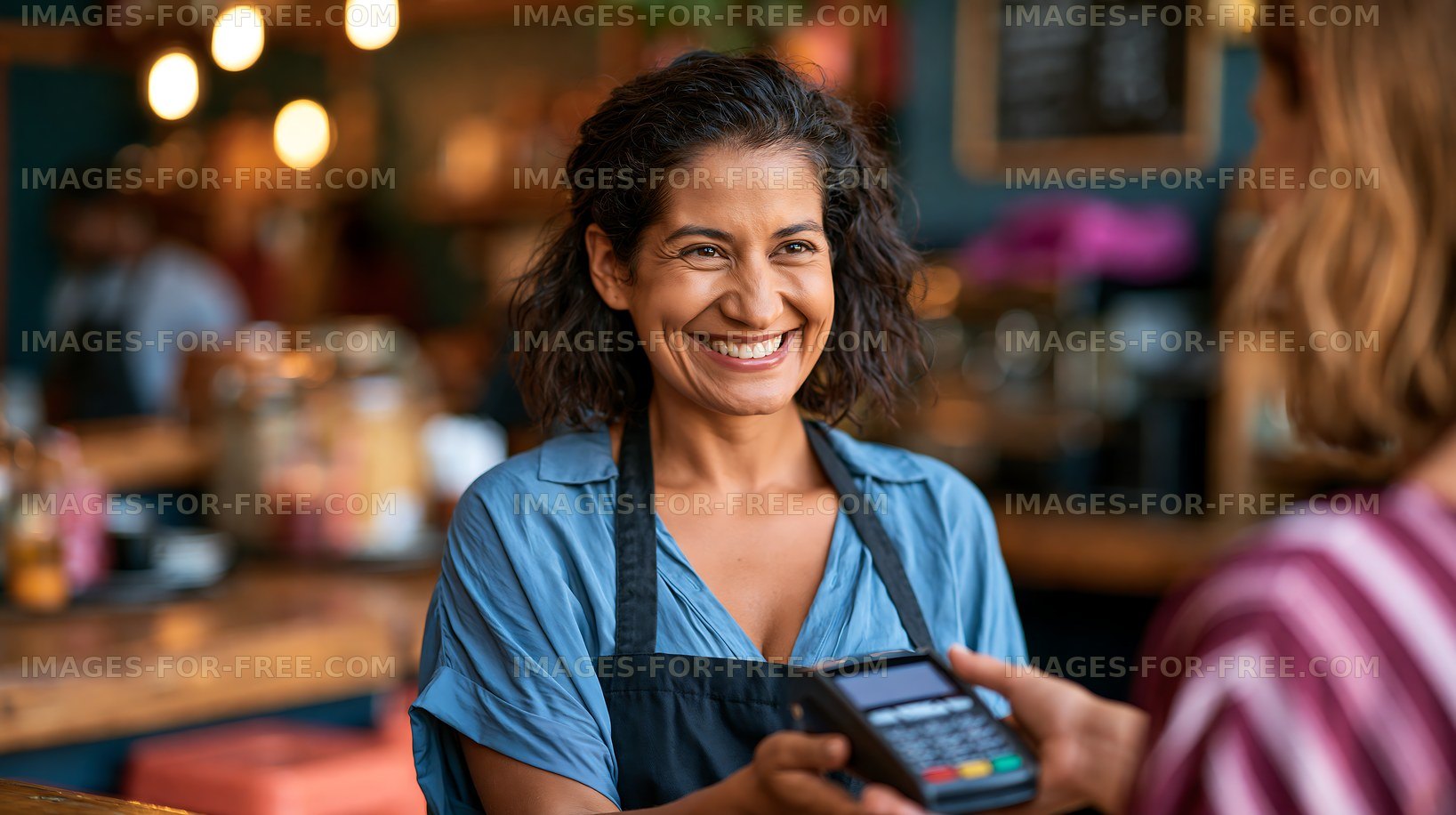 Happy woman serving customer at cafe with payment device