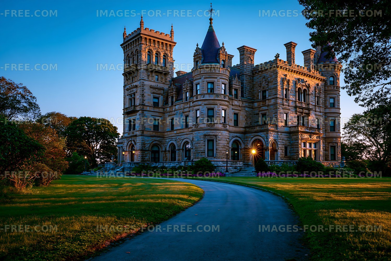 Historic mansion with stone facade and large windows at sunset