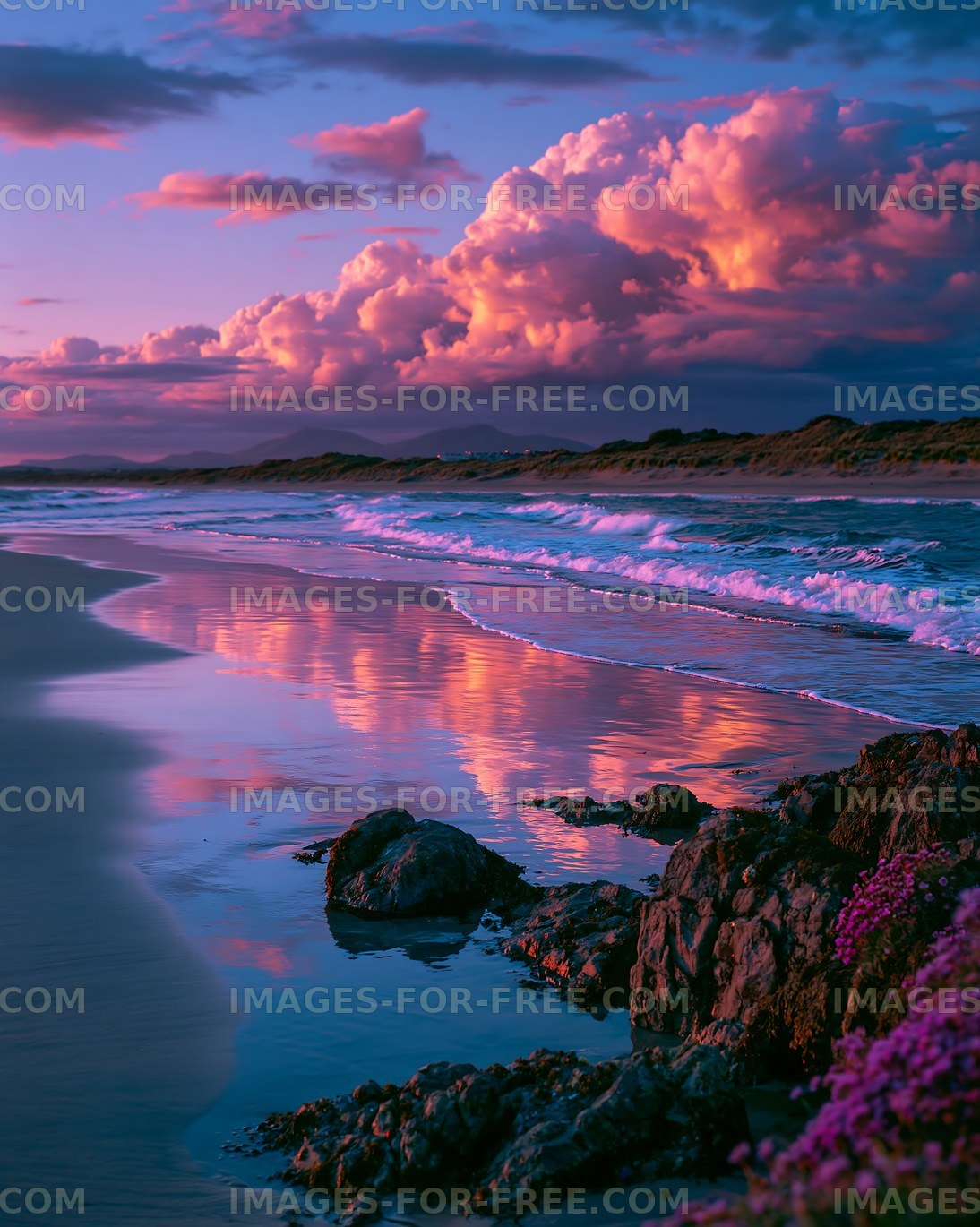 Sunset over the ocean with clouds and rocks along the shore