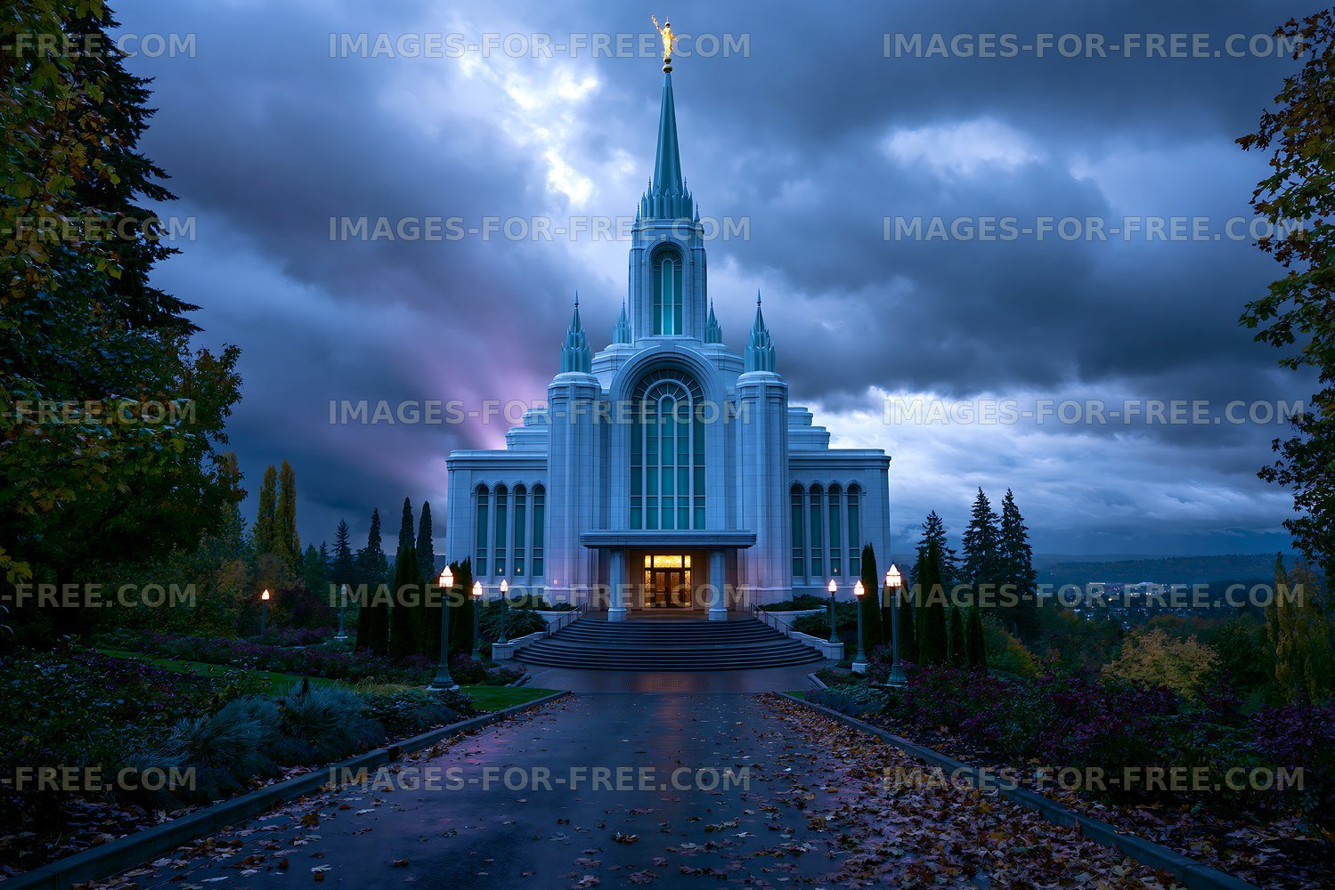 Tall building with spire under dark clouds at dusk