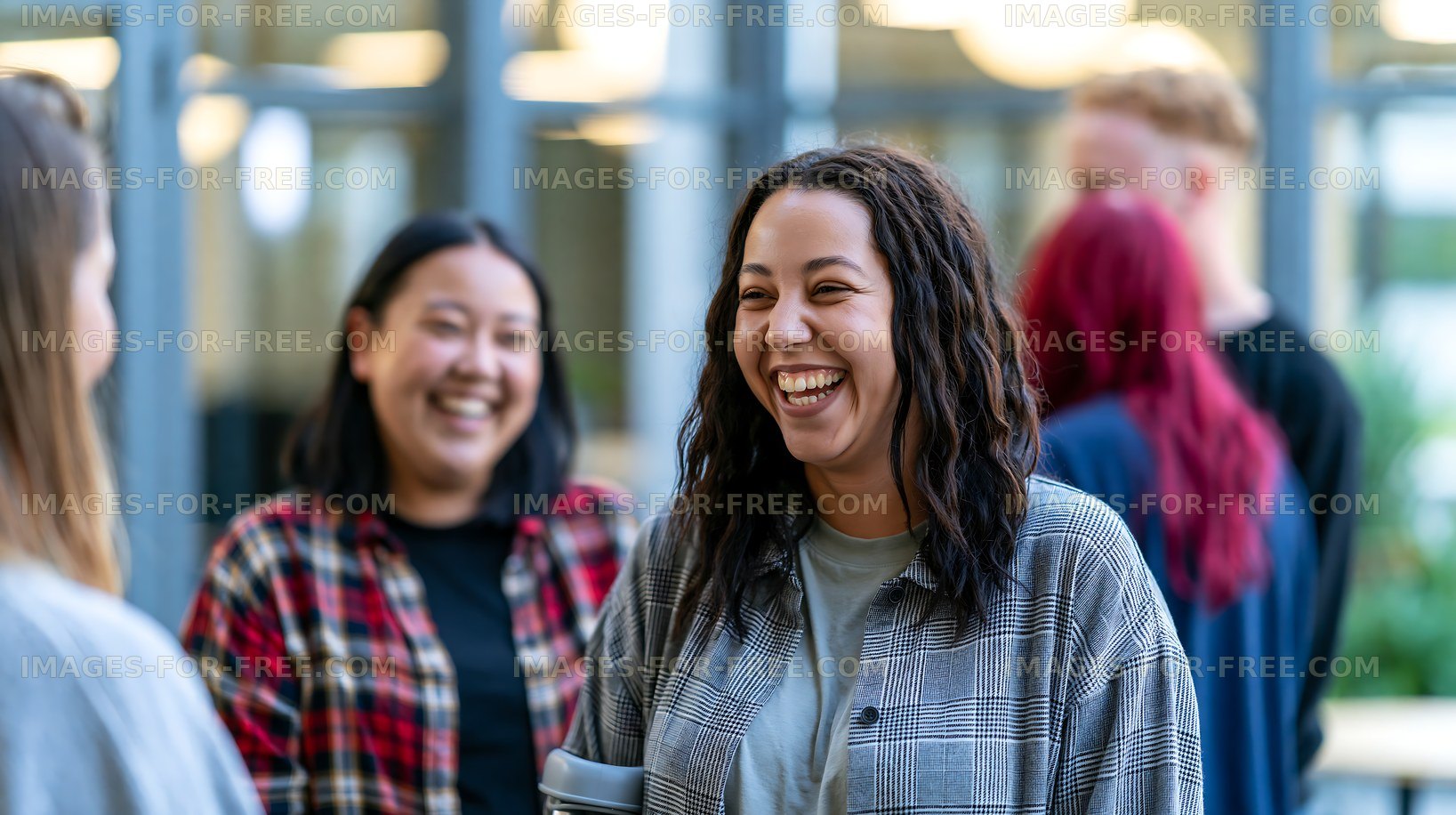 Group of friends laughing and talking indoors at a social gathering