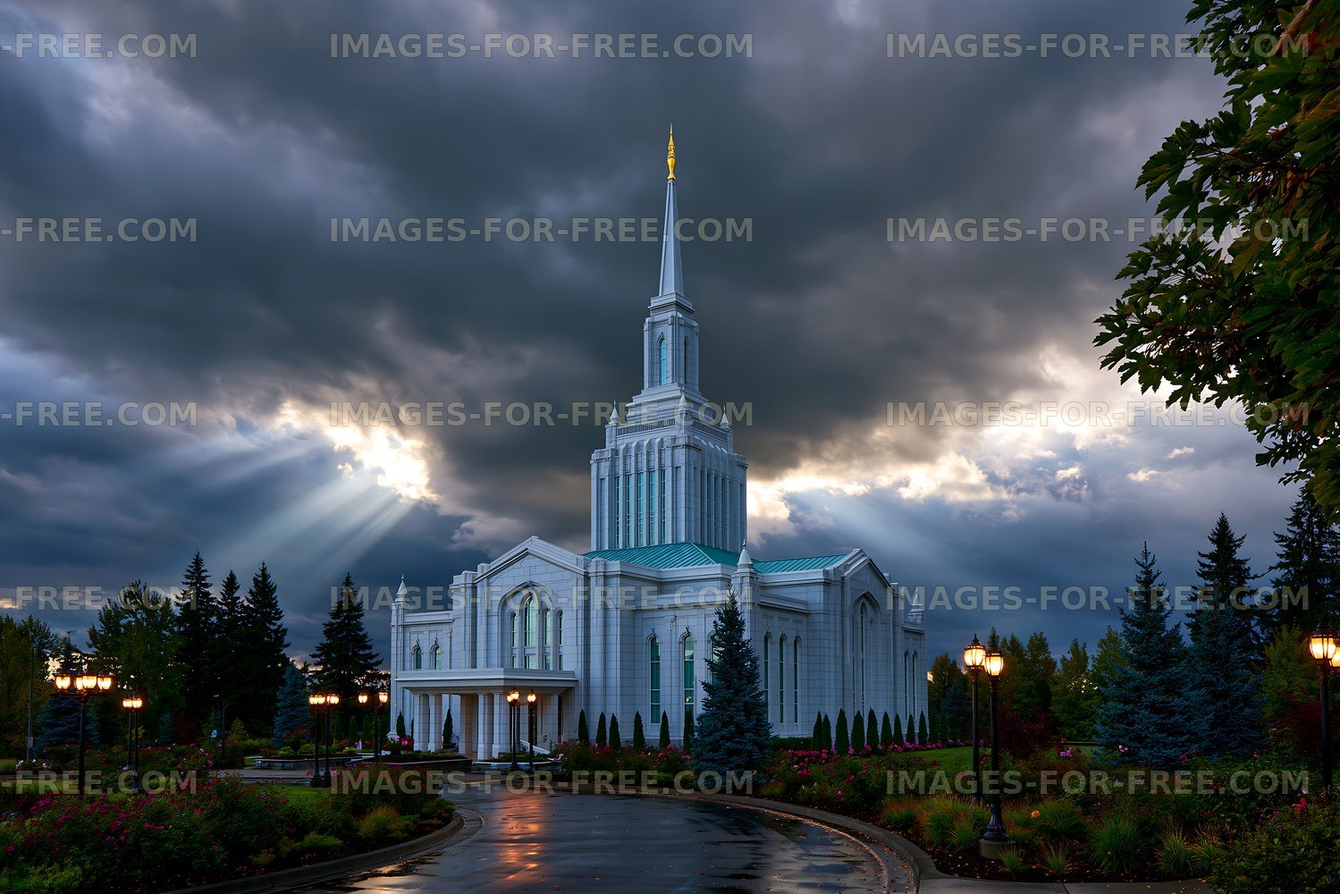 Cloudy sky over a tall white building with a spire and garden