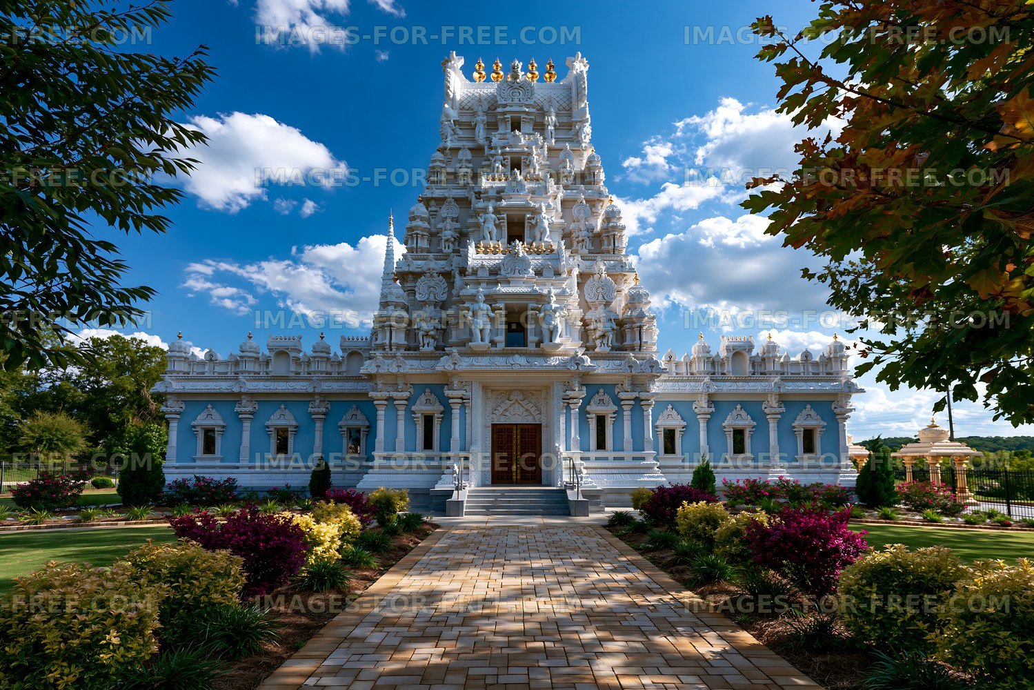 Colorful temple under a blue sky with fluffy clouds