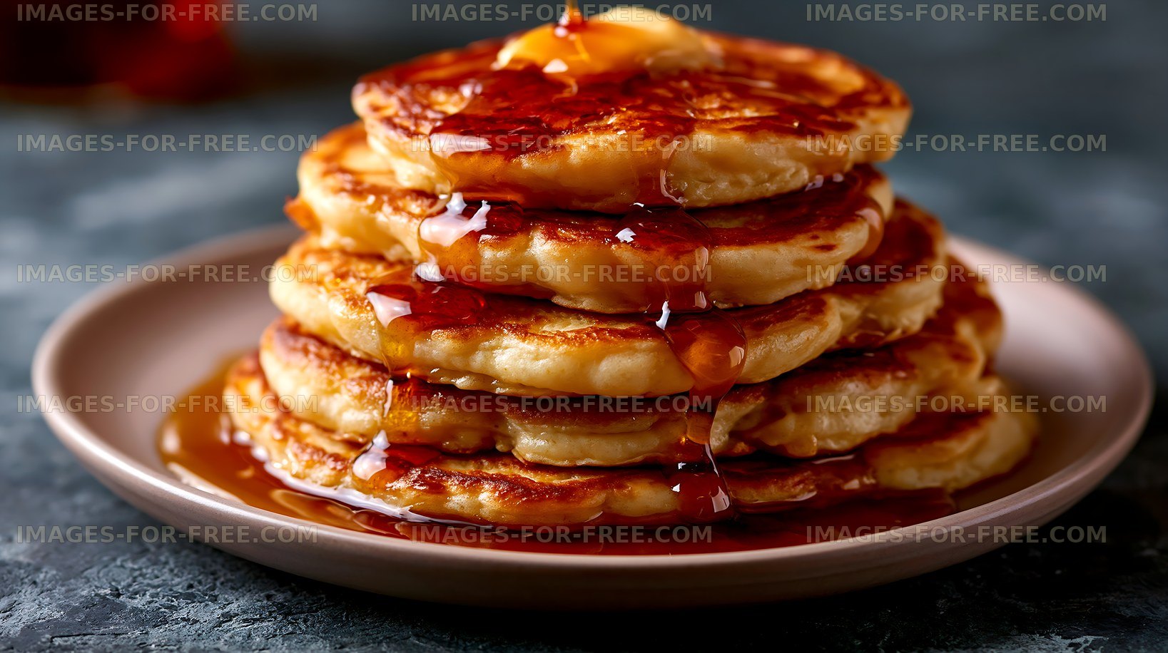 Delicious stack of pancakes drizzled with syrup on a plate