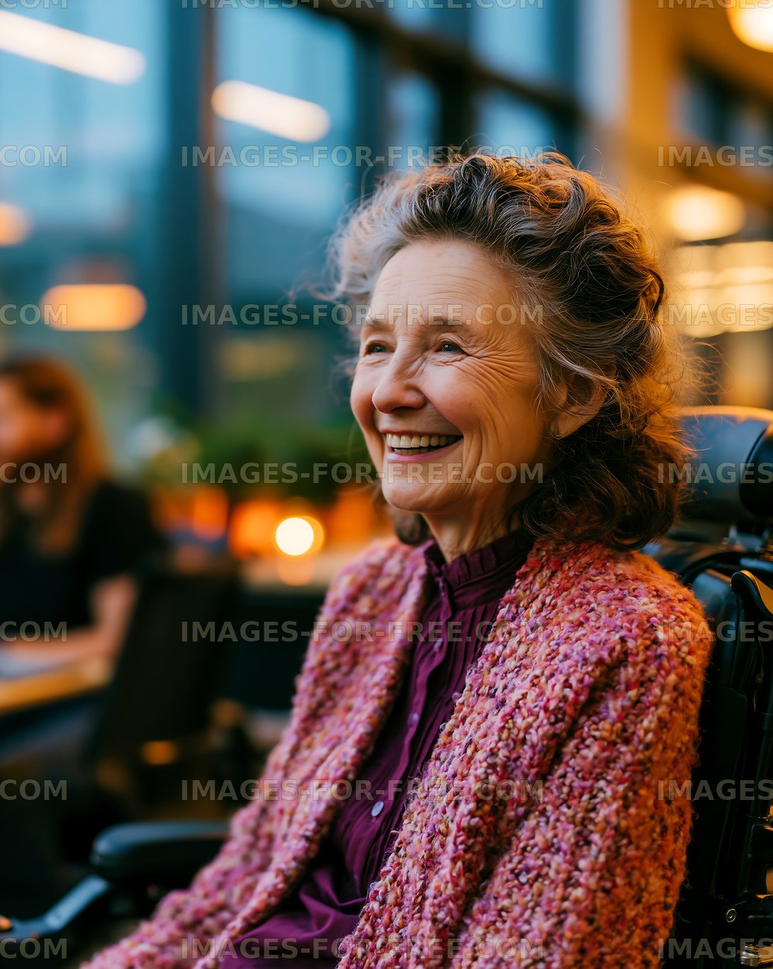 Smiling elderly woman in wheelchair at indoor cafe