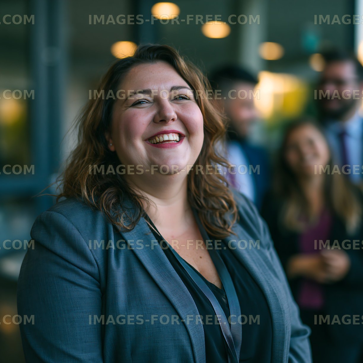 Woman in business attire smiling with colleagues in office setting