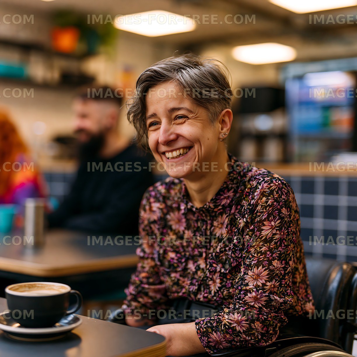 Woman smiling in a modern cafe with friends in the background