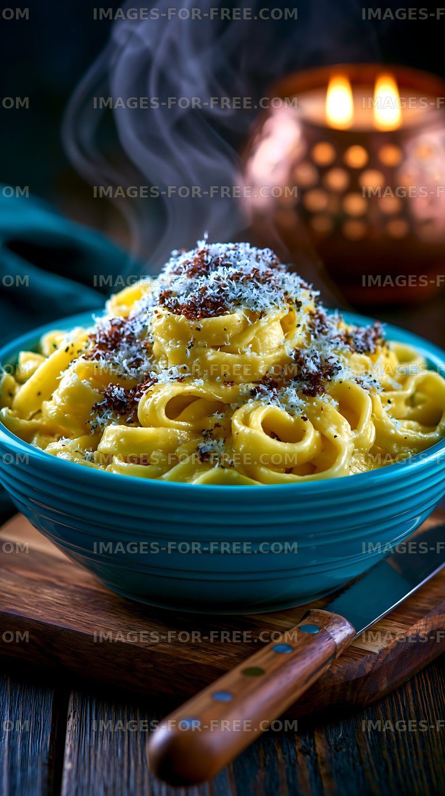 Creamy pasta served in a blue bowl with cheese and herbs