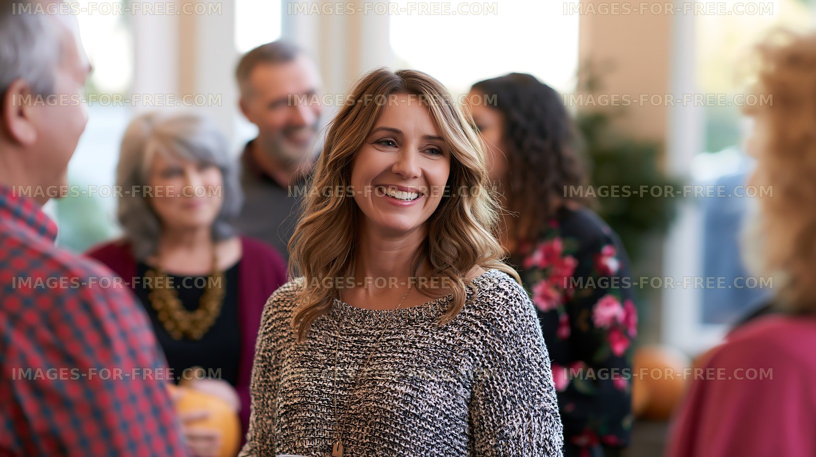 People socialize and laugh at a gathering during autumn