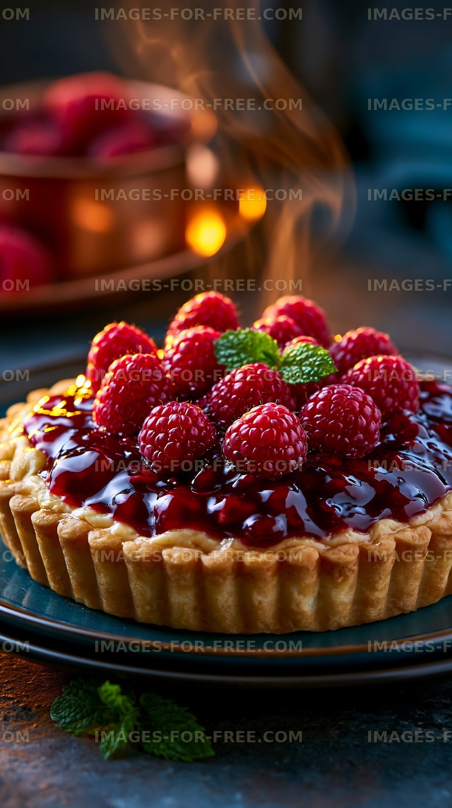 Raspberry tart with fresh berries and glossy glaze on a table
