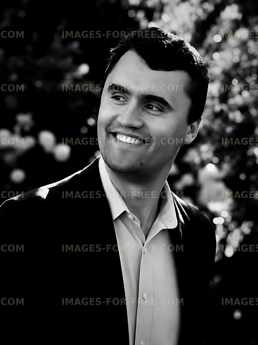 Man smiling outdoors with blurred floral background