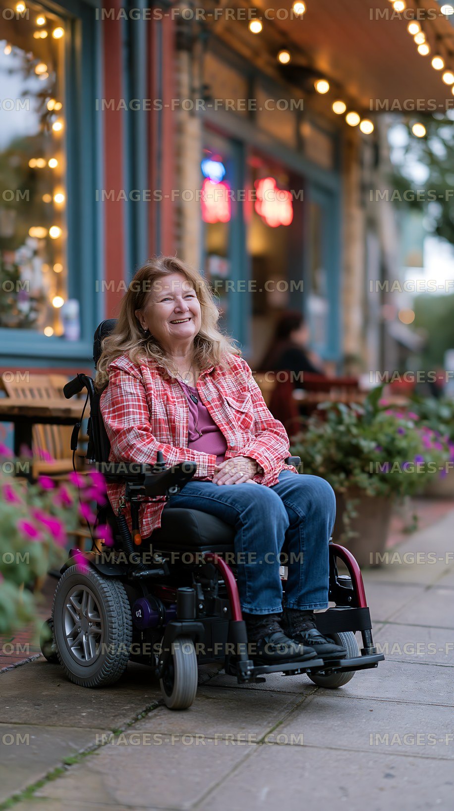 Woman in wheelchair enjoys time outside a cafe with flowers