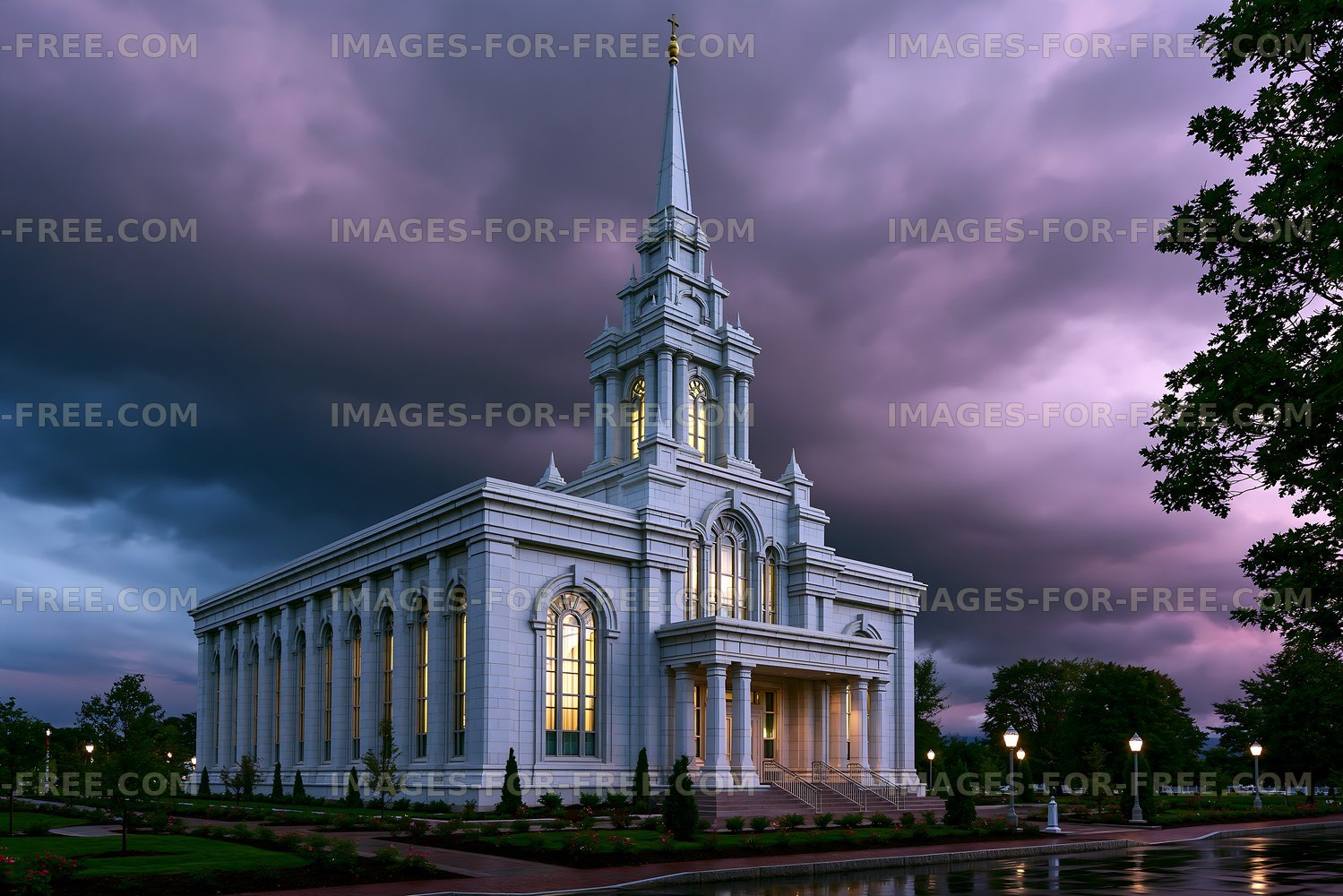Tall building with spire against a dark sky at dusk