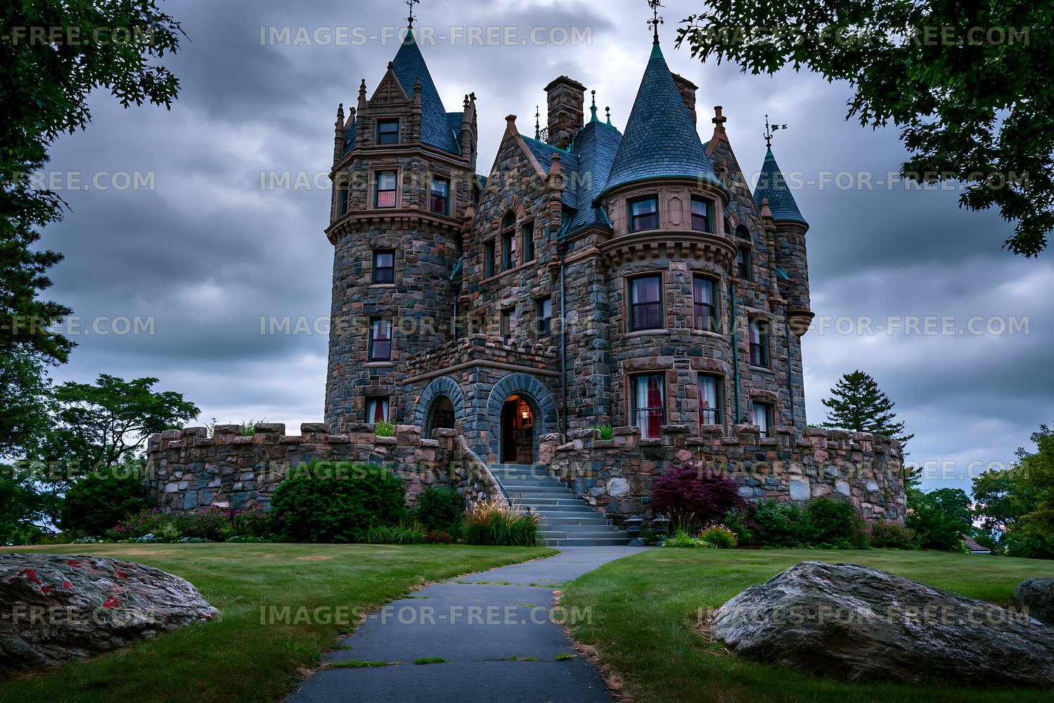 Historic stone castle under a cloudy sky in a garden area