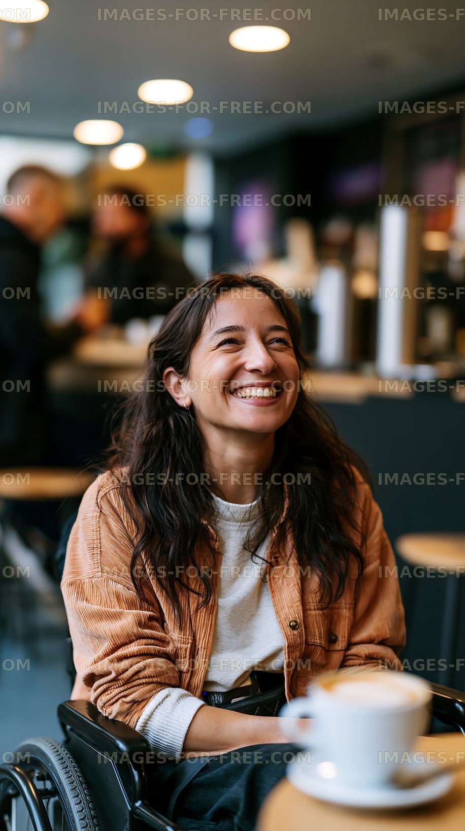 Woman smiling in a cafe while seated in a wheelchair