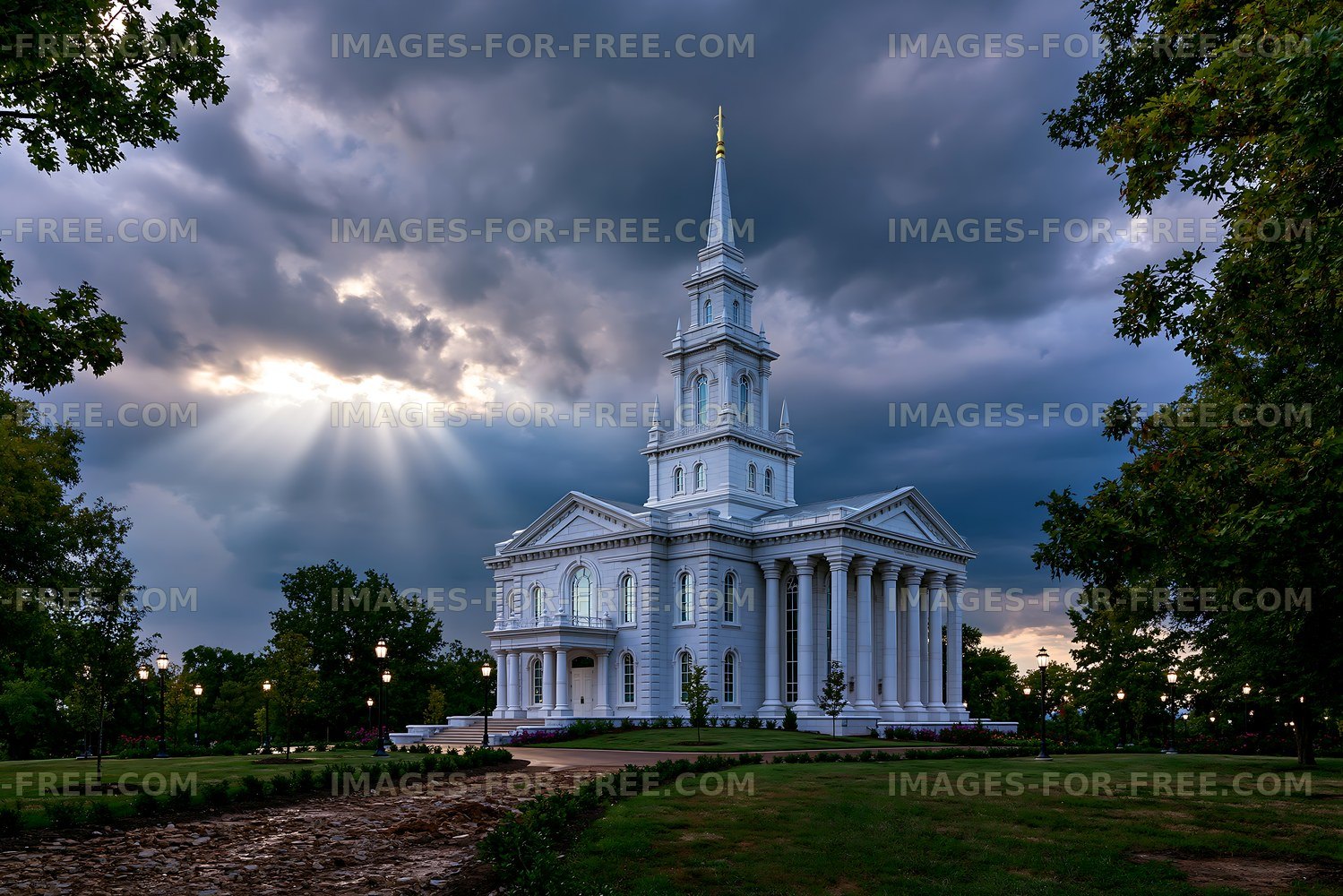 White church building under cloudy sky with sunlight beams