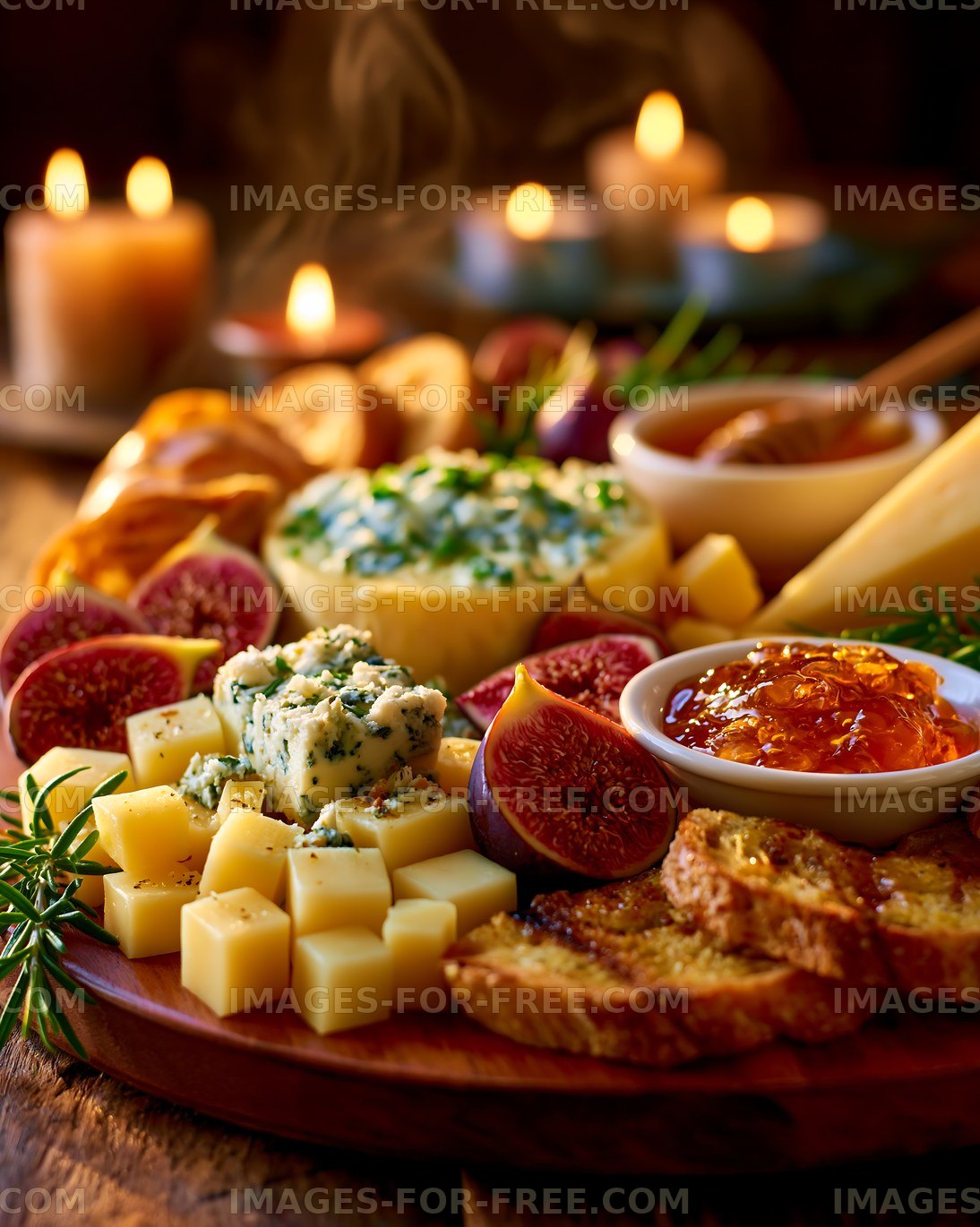 Cheese and fruit platter with candles on a wooden table