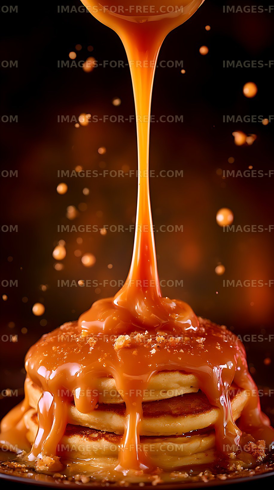 Pancakes topped with caramel sauce on a dark plate