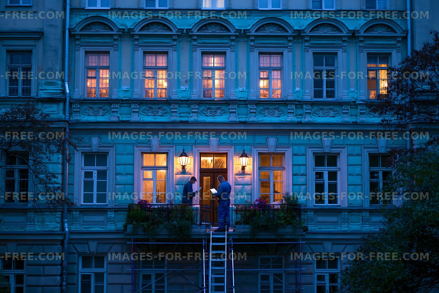Workers restoring a historic building at night near the entrance