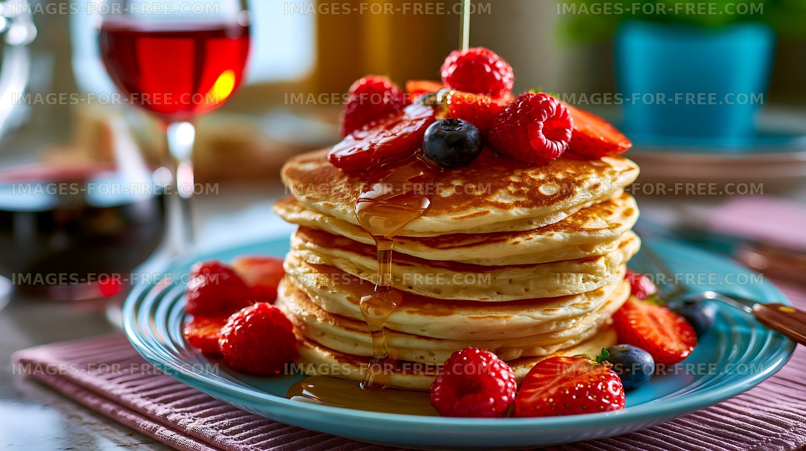 Stack of pancakes topped with berries and syrup on a plate