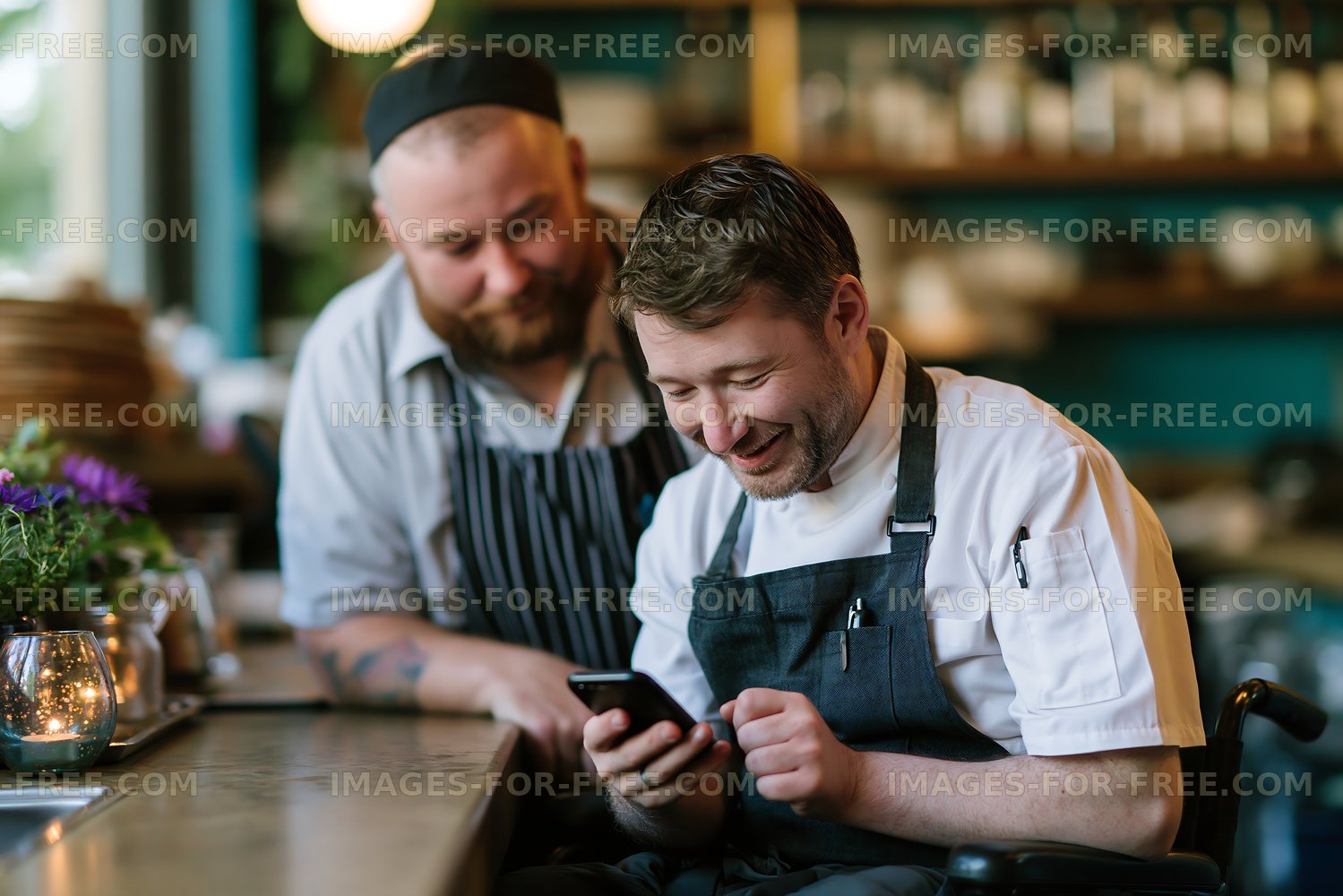 Chefs smiling while looking at a phone in a restaurant
