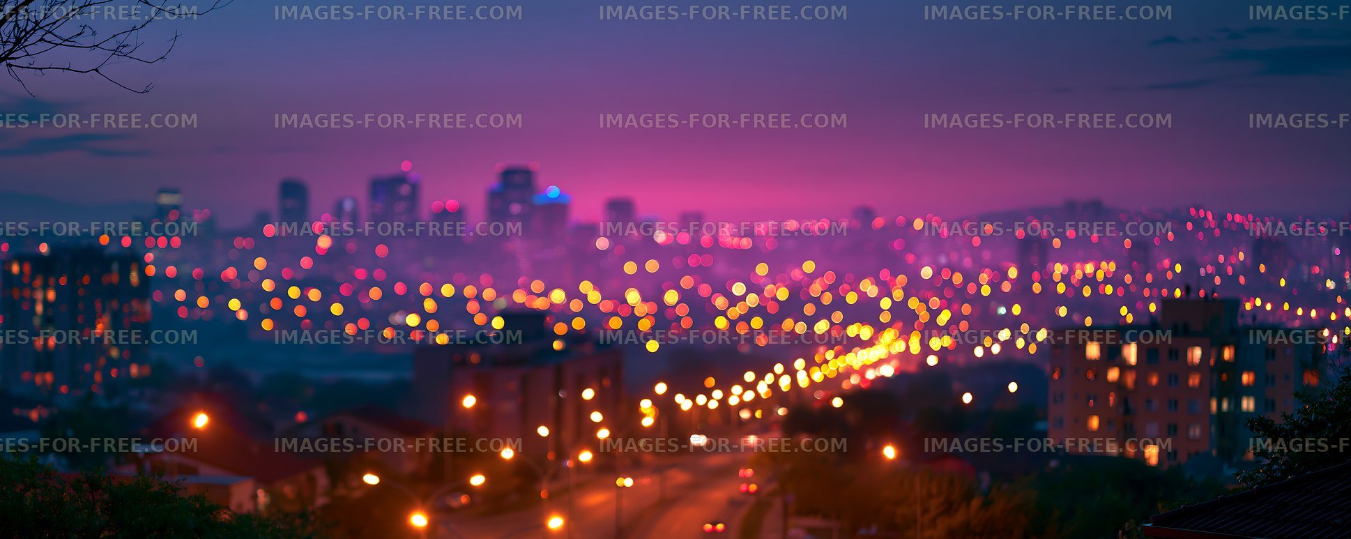 City skyline at dusk with lights shining in the street