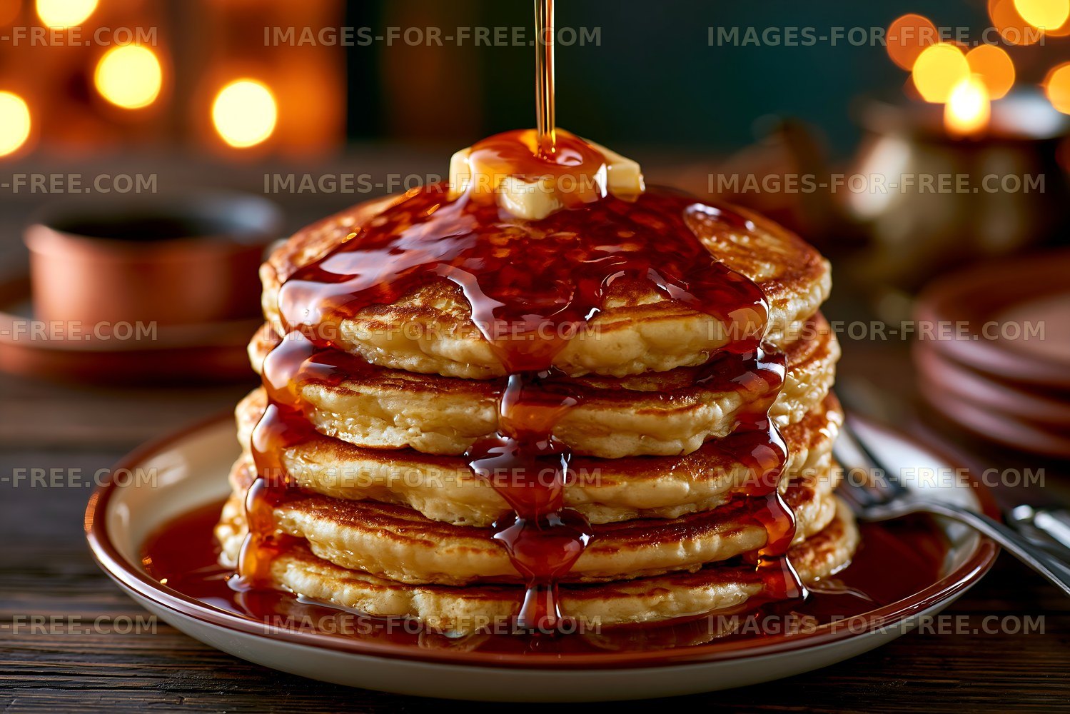 Stack of pancakes with syrup and butter on a plate