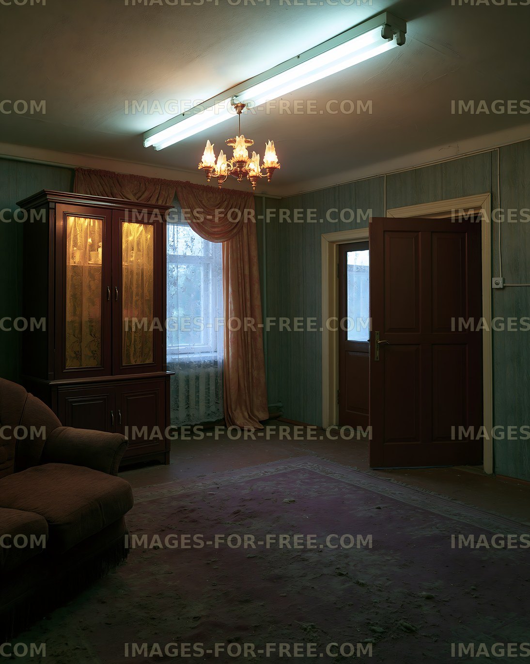 Interior of a vintage living room with a chandelier and large window