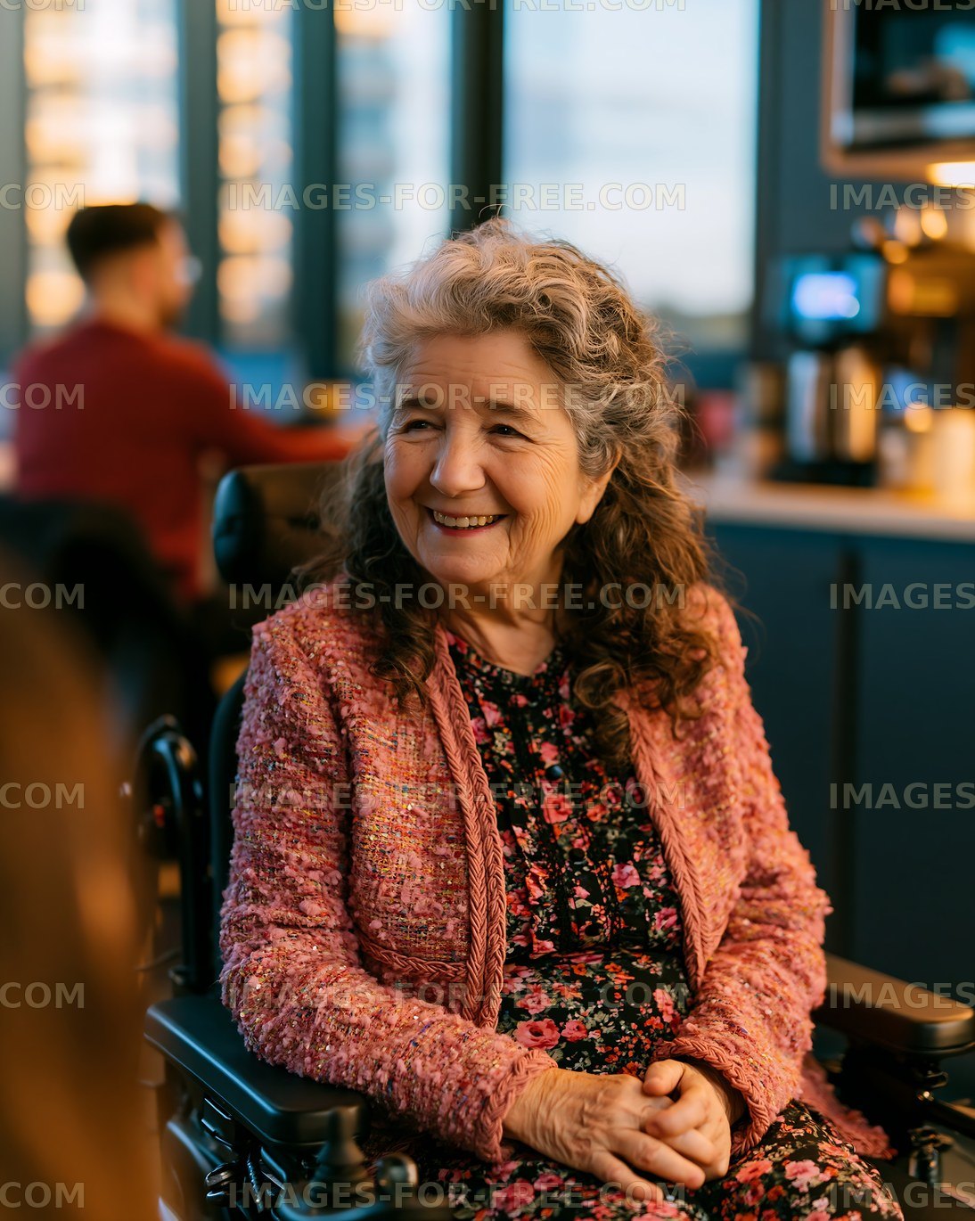 Woman in wheelchair smiling in a modern café setting