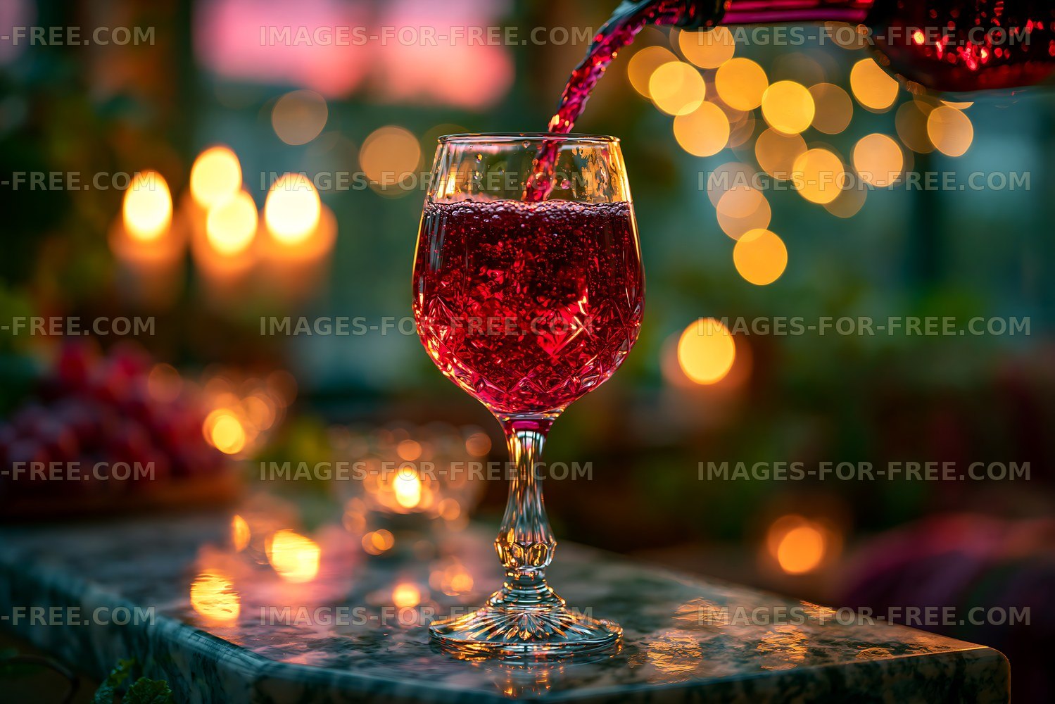 Red beverage in glass with warm lights in the background