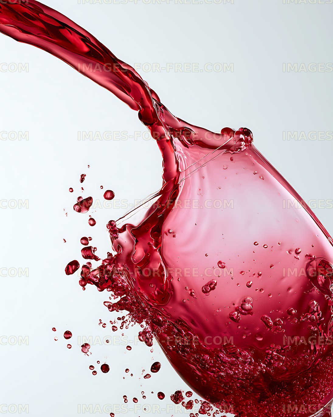 Red wine splashing into a glass with droplets