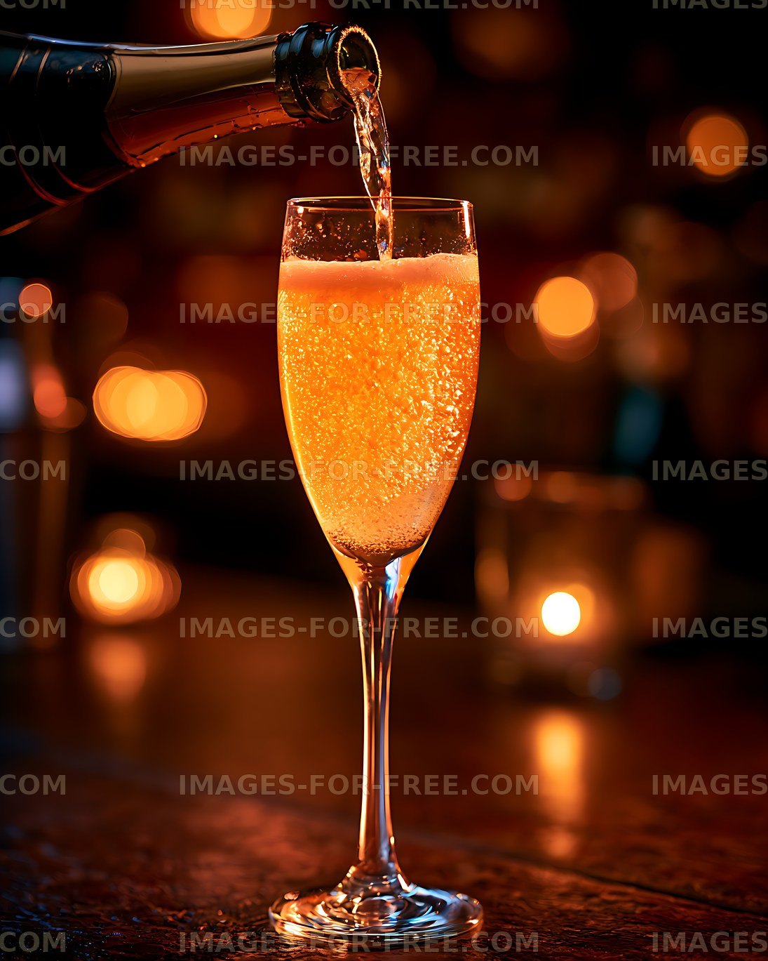 Champagne being poured into a glass at a bar setting