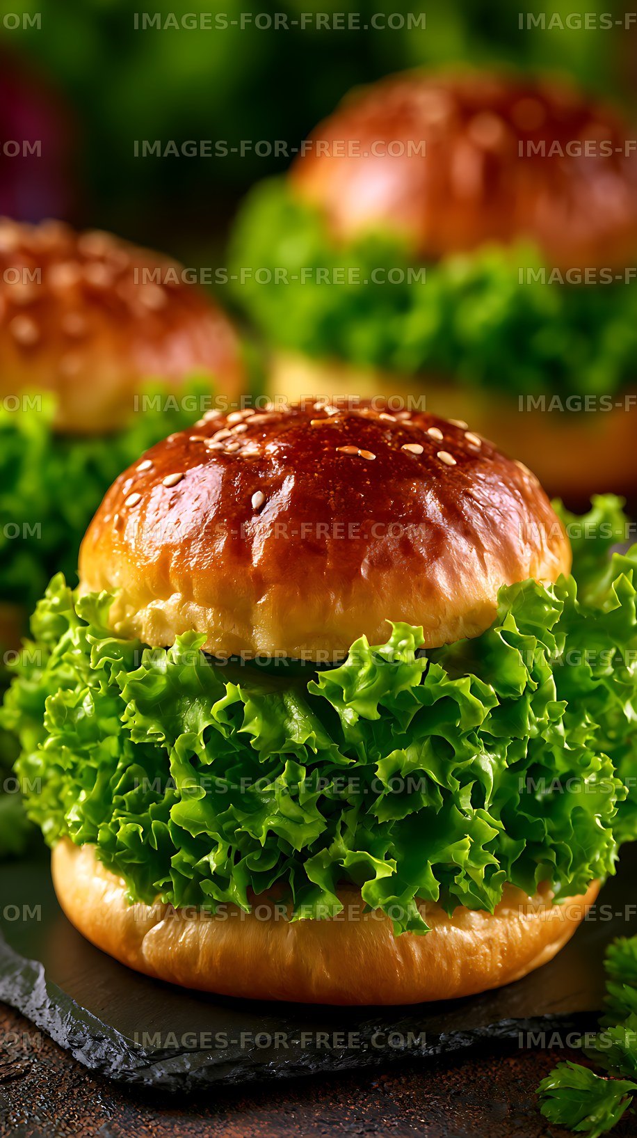 Fresh burgers with lettuce on a dark surface