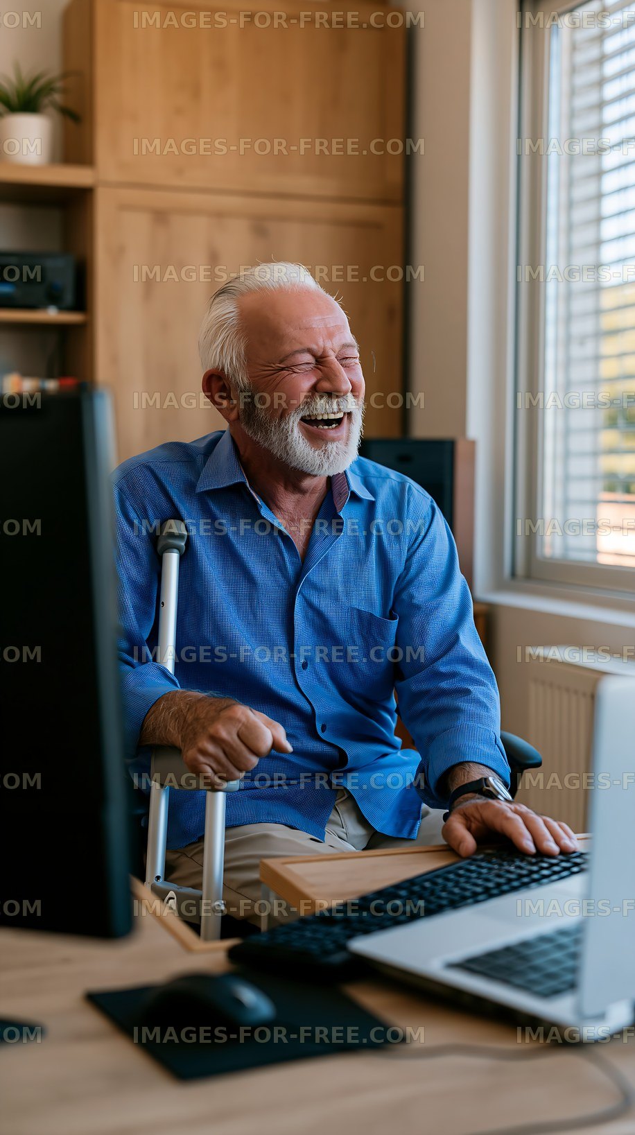 Senior man using computer at home office with warm smile