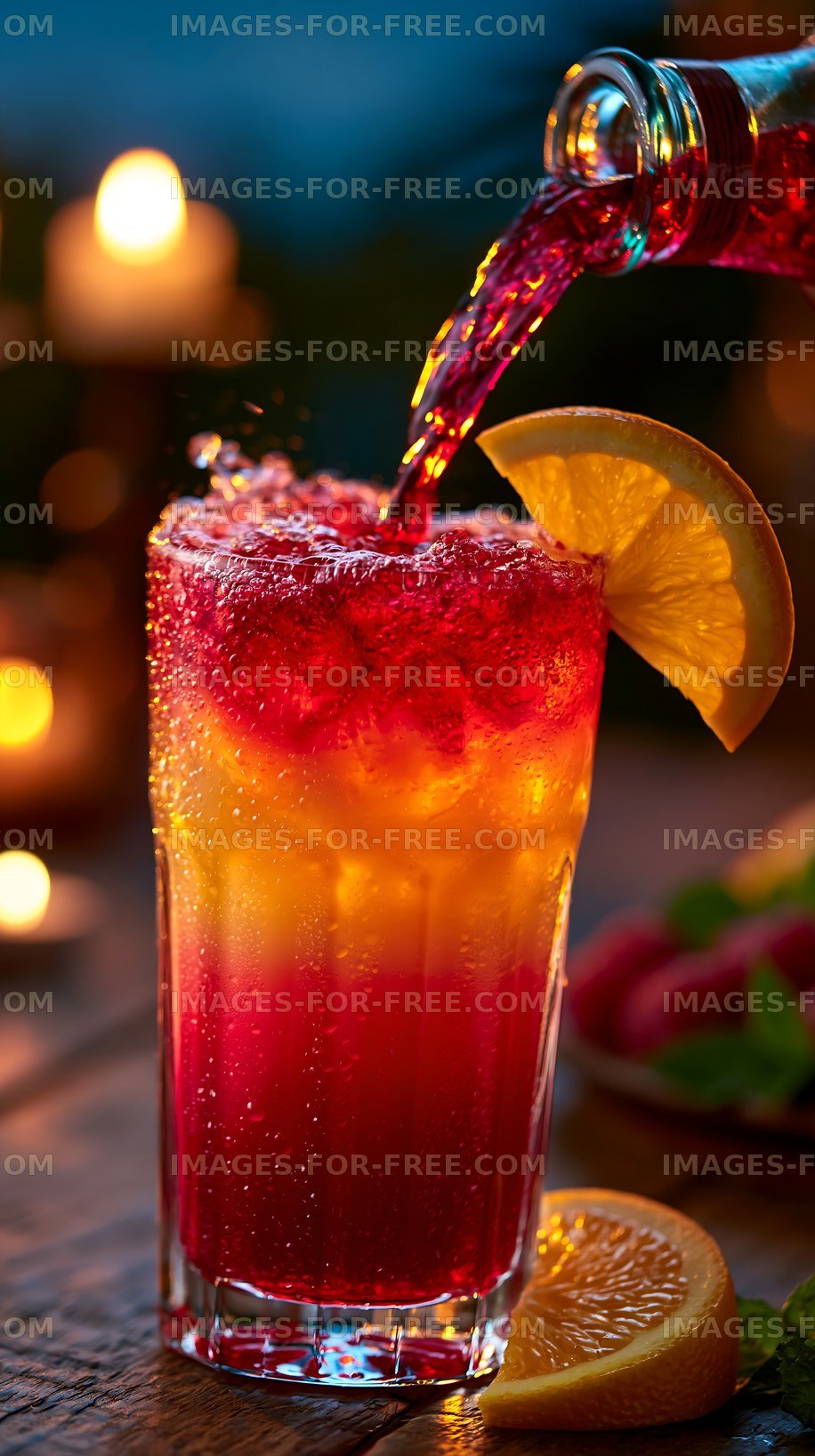 Colorful drink being poured into a glass with fruit garnish