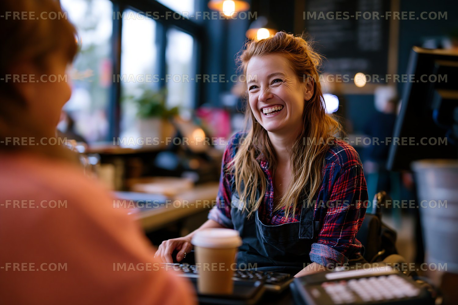 Barista serving coffee in a busy cafe
