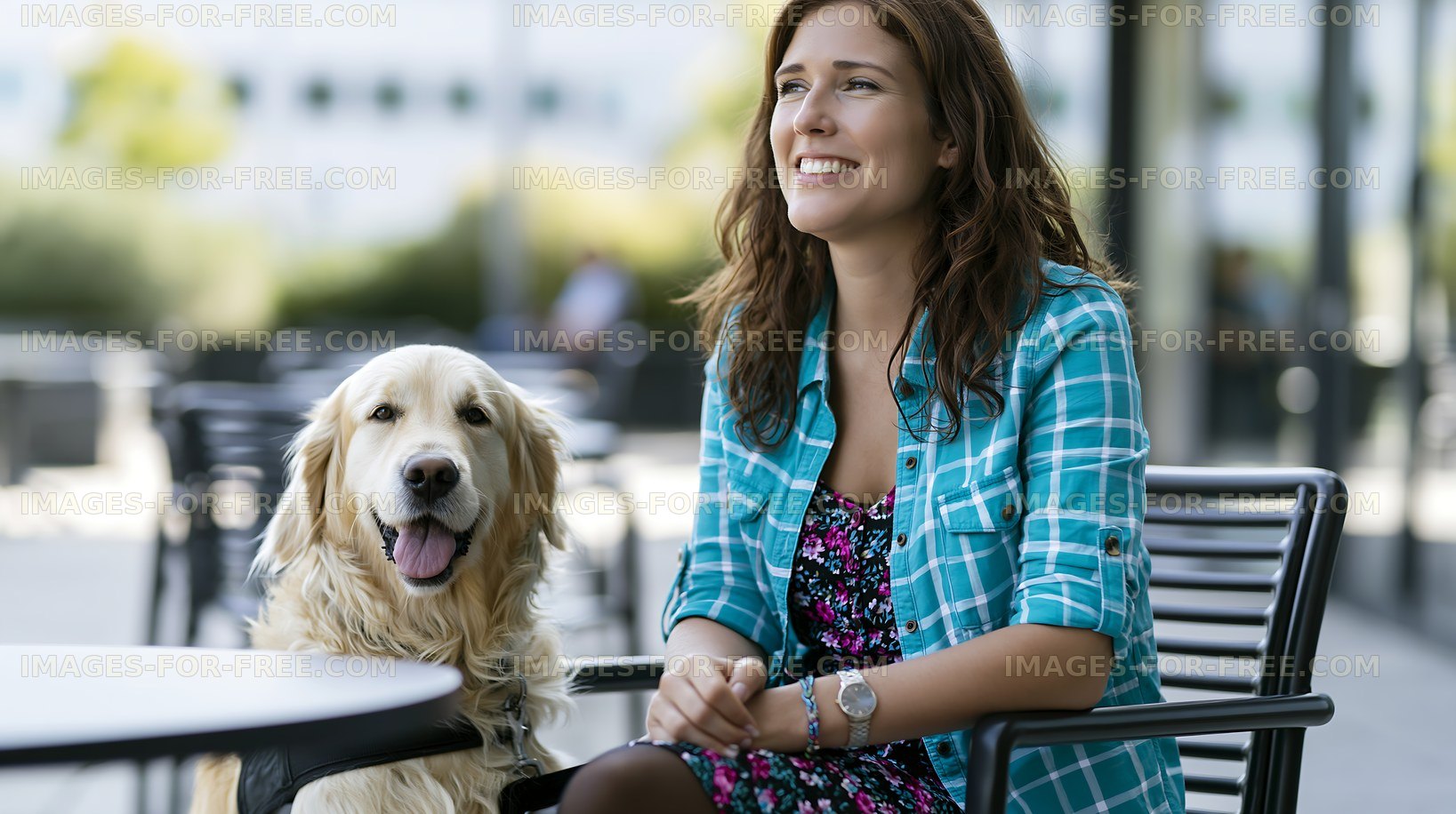 Smiling woman sitting with golden retriever at outdoor cafe