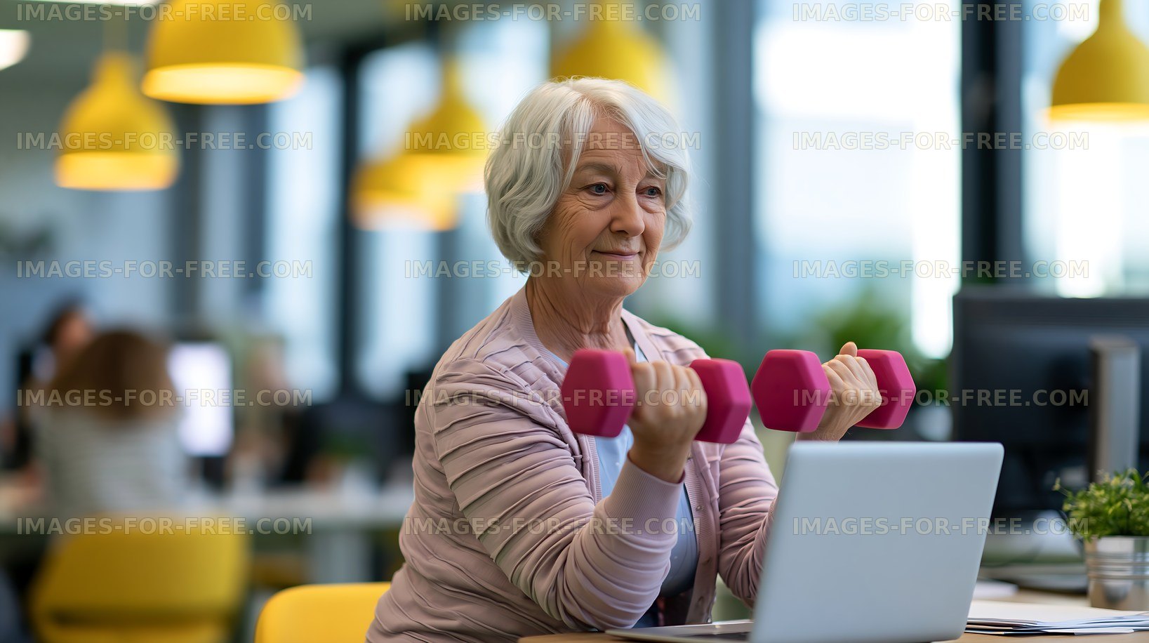 Senior woman exercises with dumbbells at a bright office