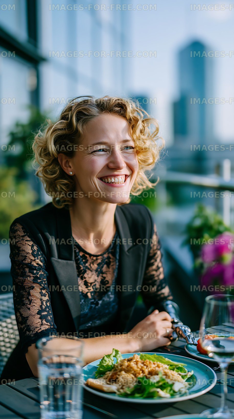 Woman enjoying meal at outdoor restaurant with city view