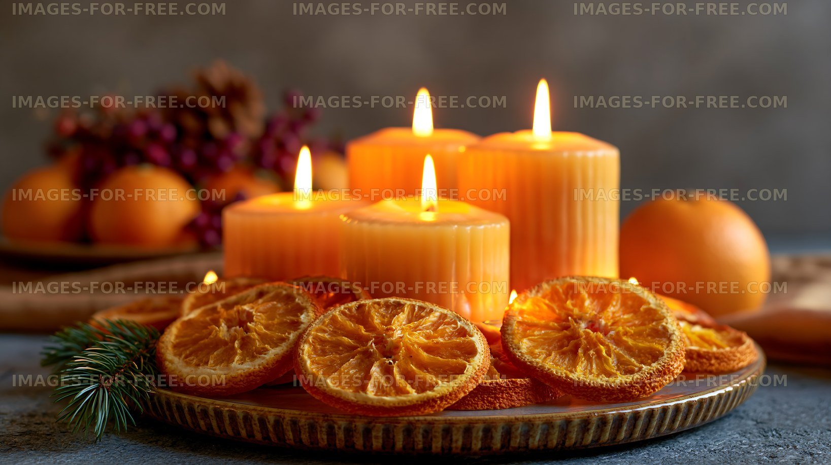 Decorative candles with dried oranges on a table
