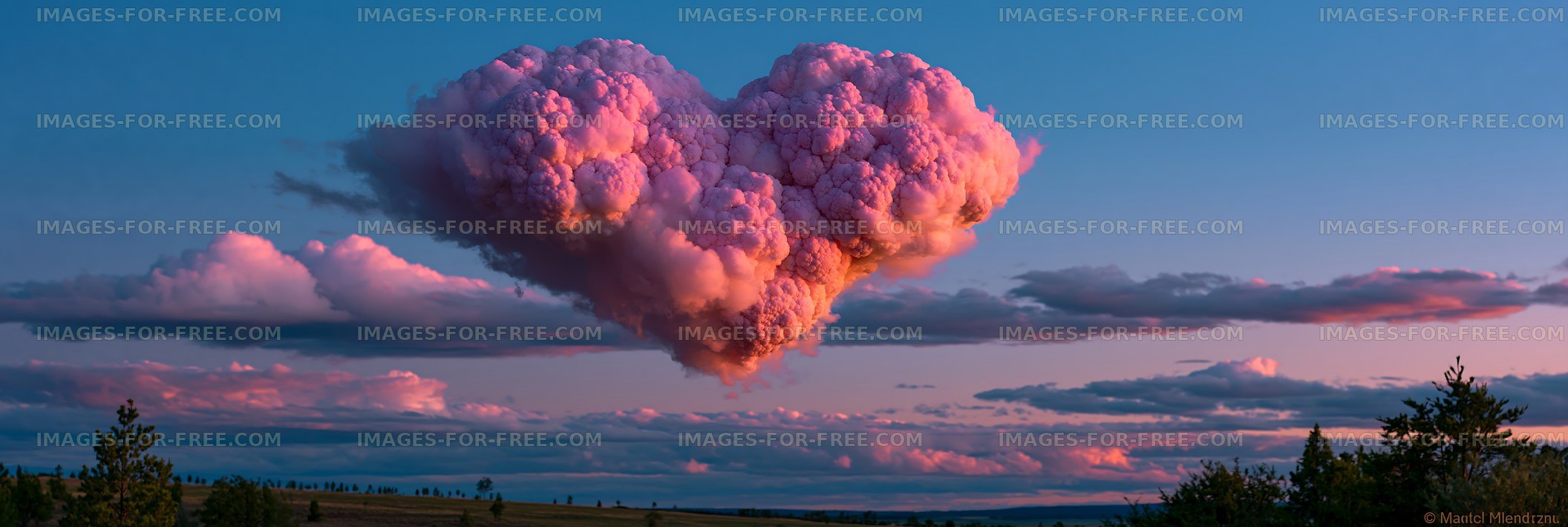 Towering pink storm cloud at sunset
