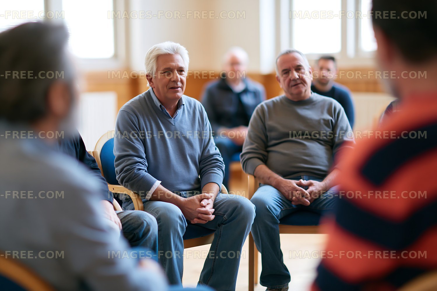 Older men participating in an indoor group discussion